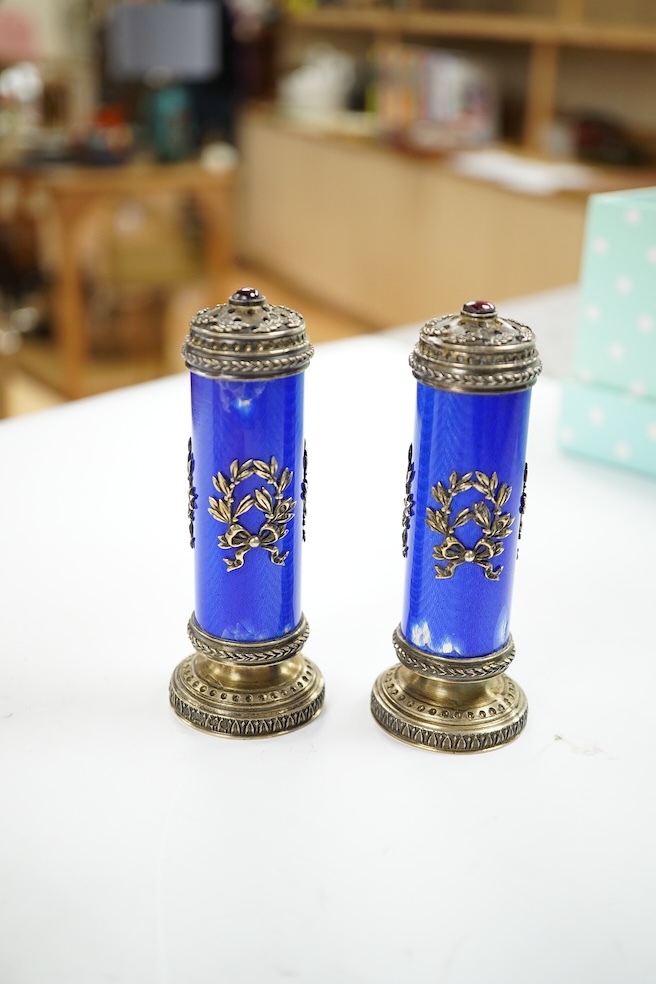 A cased pair of Russian style white metal and enamel cylindrical pedestal pepperettes, 10cm, enamel a.f. Condition - poor